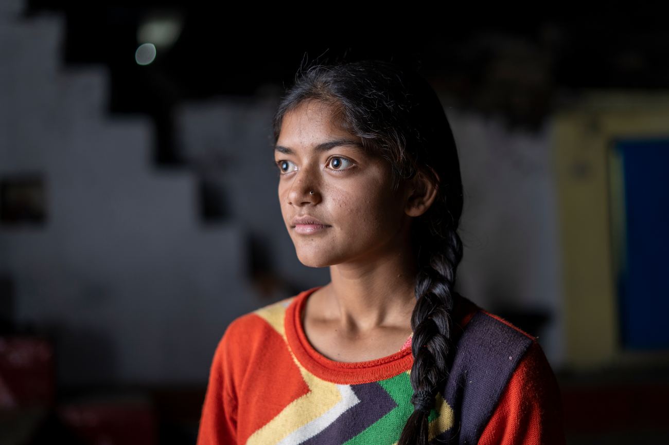 A young woman looking toward the light with quiet hope